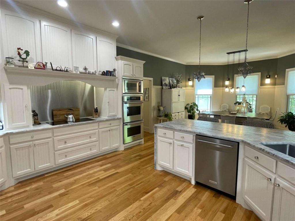 1531 Overlook Pass Road Monroe, GA 30655 - Photo 16 of 78 a kitchen with stainless steel appliances kitchen island granite countertop a stove a sink and a refrigerator