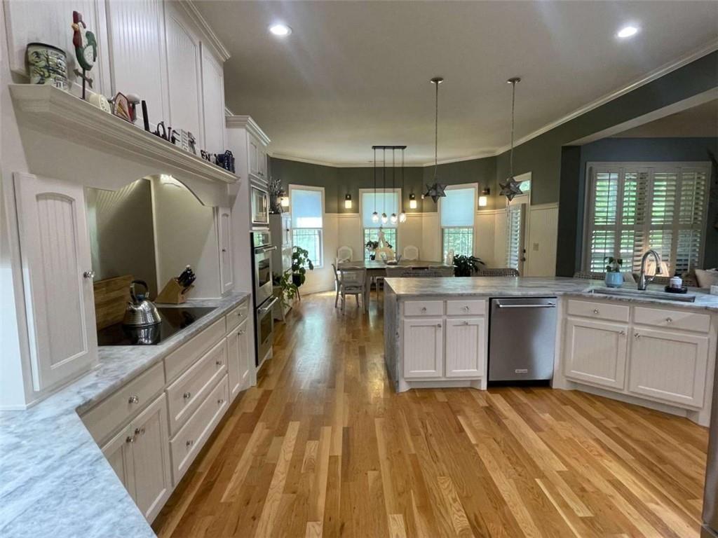 1531 Overlook Pass Road Monroe, GA 30655 - Photo 18 of 78 a large kitchen with stainless steel appliances kitchen island granite countertop a large counter top a sink a stove and a refrigerator