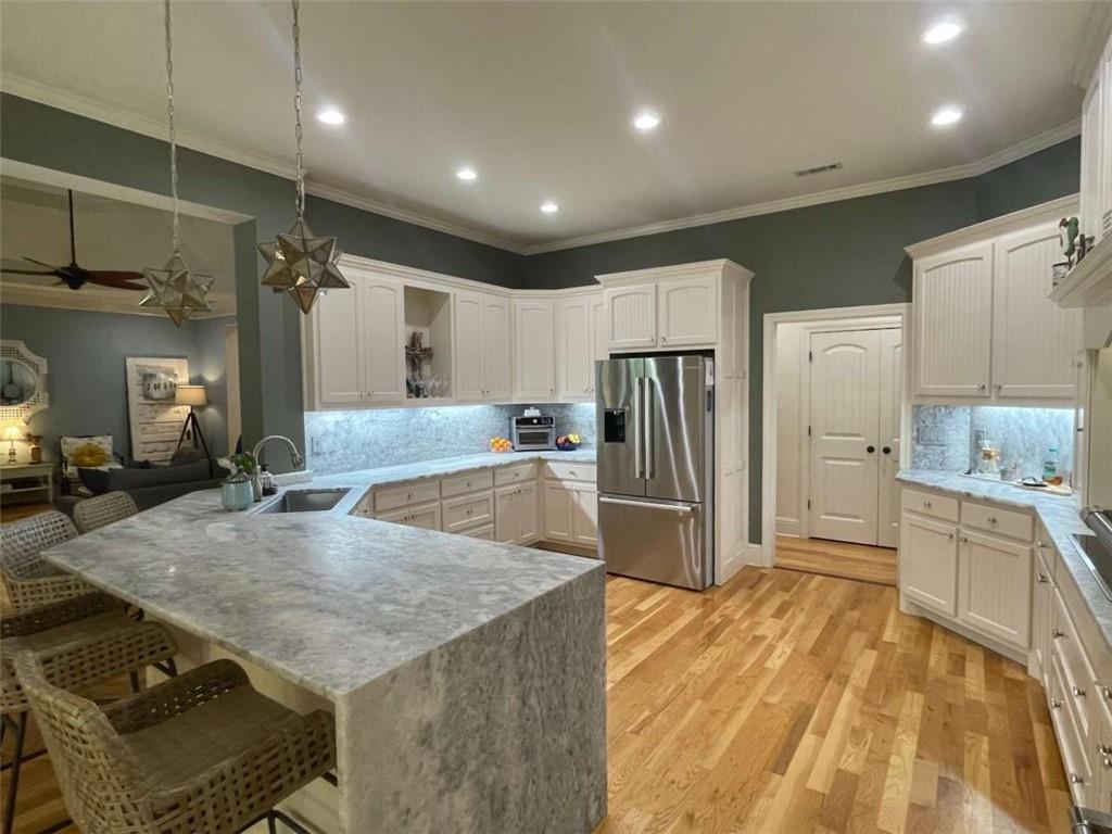 1531 Overlook Pass Road Monroe, GA 30655 - Photo 19 of 78 a kitchen with stainless steel appliances granite countertop a sink refrigerator and cabinets