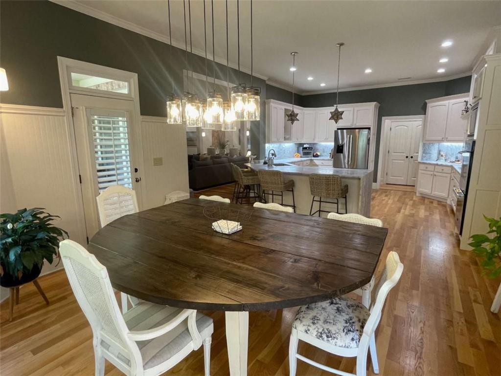 1531 Overlook Pass Road Monroe, GA 30655 - Photo 22 of 78 a dining room with stainless steel appliances furniture large window and wooden floor