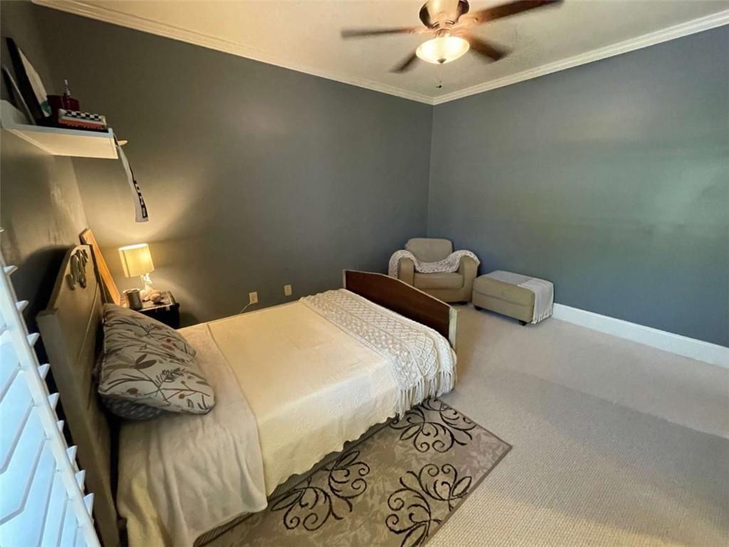 1531 Overlook Pass Road Monroe, GA 30655 - Photo 40 of 78 a bedroom with a bed and ceiling fan