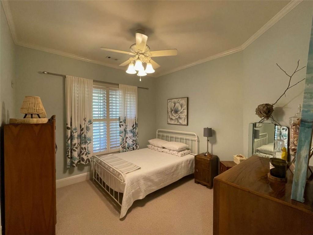 1531 Overlook Pass Road Monroe, GA 30655 - Photo 42 of 78 a bedroom with a bed and a chandelier