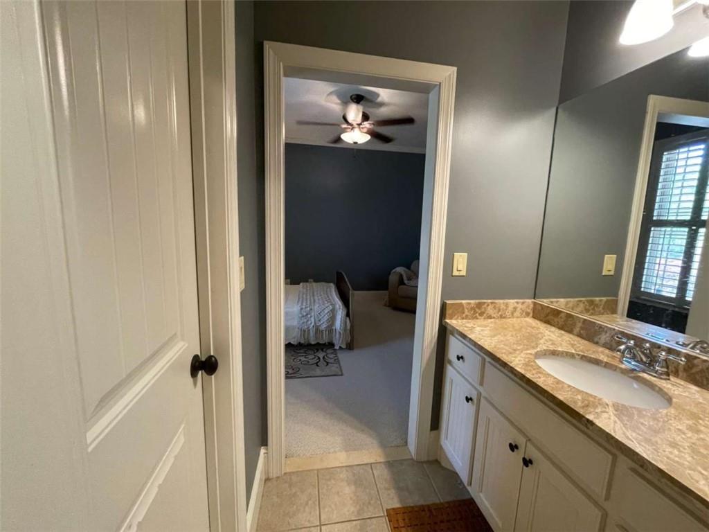 1531 Overlook Pass Road Monroe, GA 30655 - Photo 44 of 78 a en suite bathroom with a granite countertop sink and a mirror