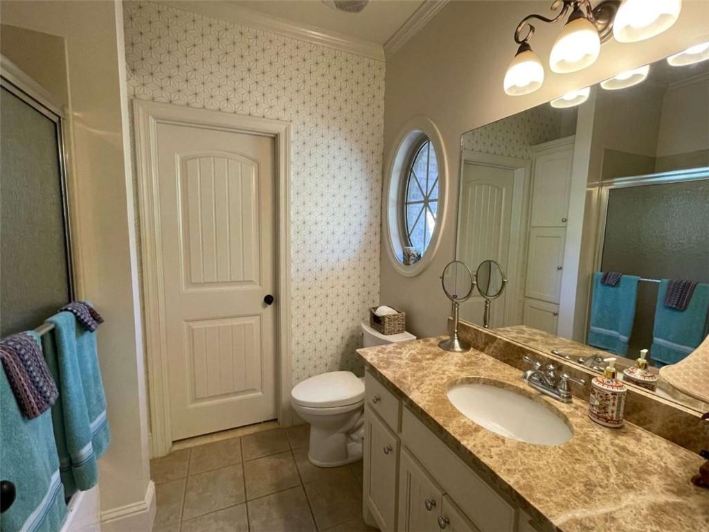 1531 Overlook Pass Road Monroe, GA 30655 - Photo 45 of 78 a bathroom with a granite countertop sink a toilet and a mirror