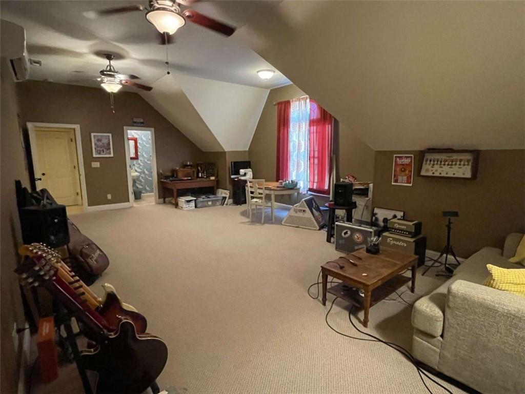 1531 Overlook Pass Road Monroe, GA 30655 - Photo 49 of 78 a living room with furniture a chandelier and a large window