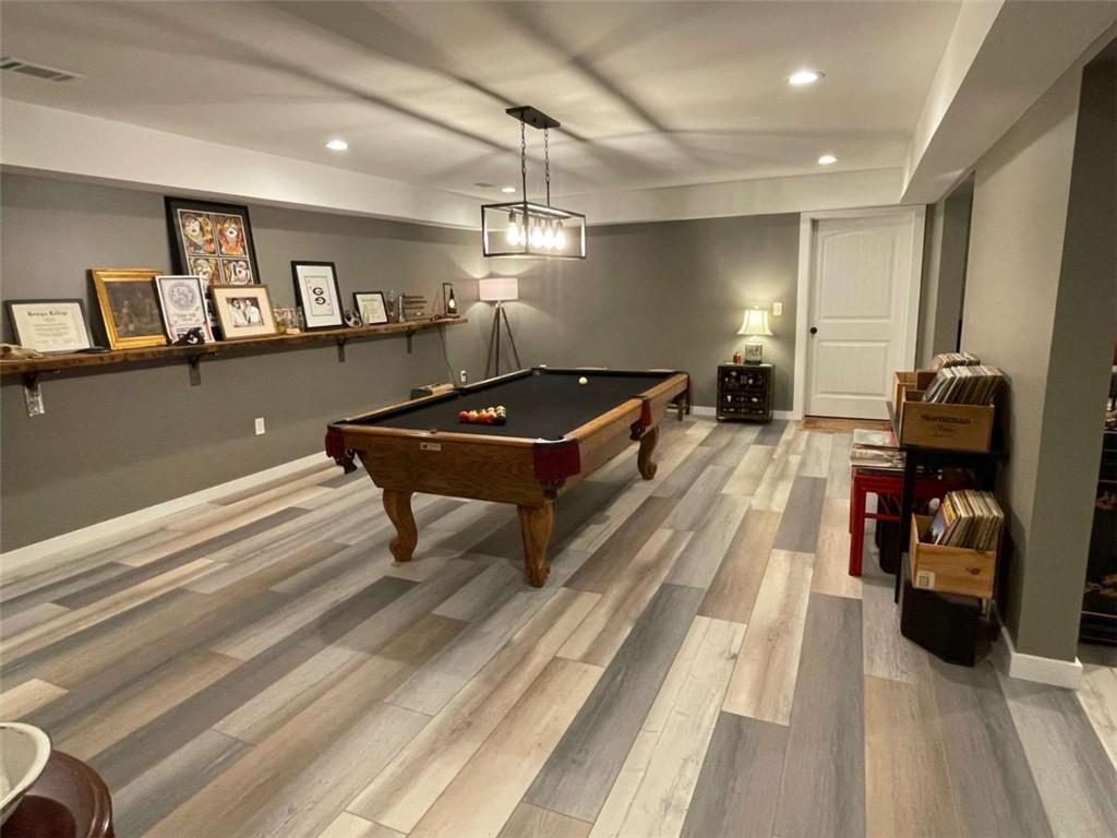 1531 Overlook Pass Road Monroe, GA 30655 - Photo 57 of 78 a living room with furniture a flat screen tv and a table