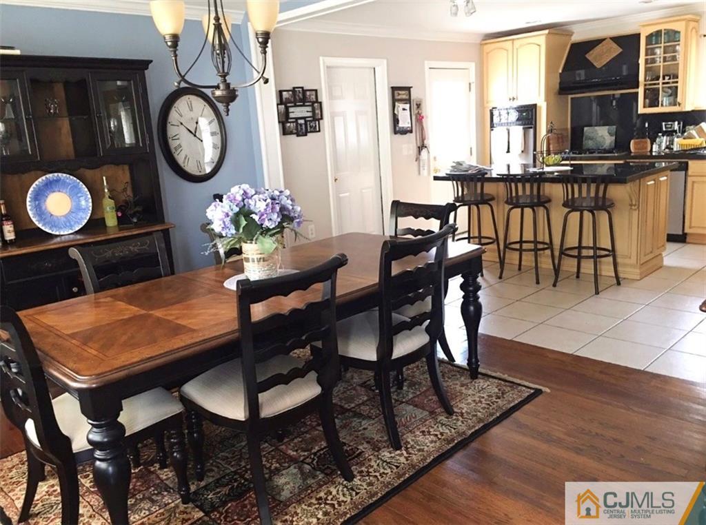 50 Dover Road Colonia, NJ 07067 - Photo 5 of 11 a dining room filled chandelier and wooden floor