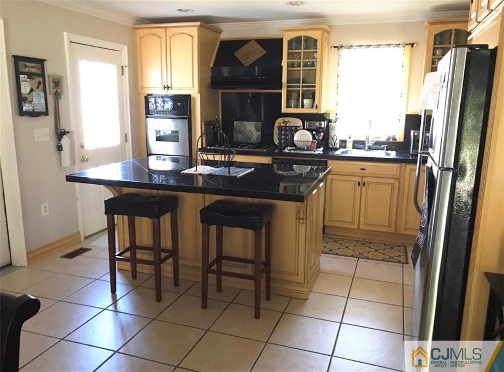 50 Dover Road Colonia, NJ 07067 - Photo 6 of 11 a kitchen with a sink a stove and refrigerator