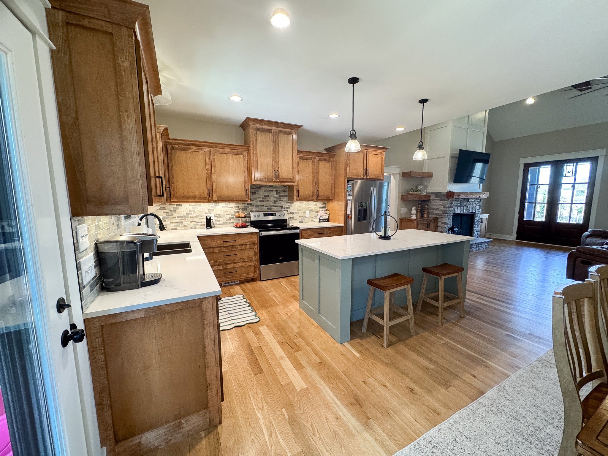 138 Belcher Hollow Road Cottontown, TN 37048 - Photo 32 of 60 a kitchen with a sink dishwasher a stove and a dining table with wooden floor