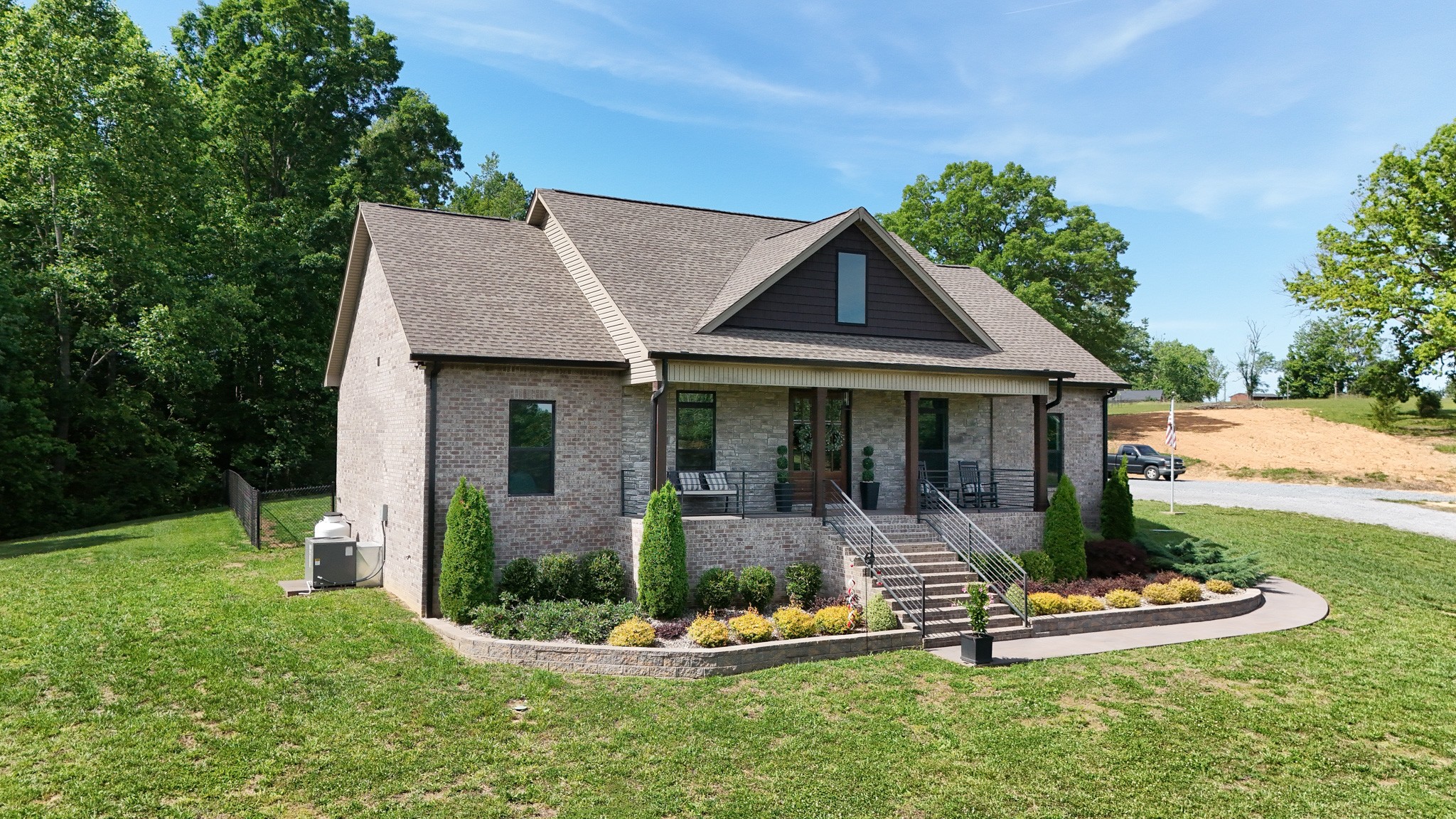 138 Belcher Hollow Road Cottontown, TN 37048 - Photo 4 of 60 a front view of a house with a yard table and chairs