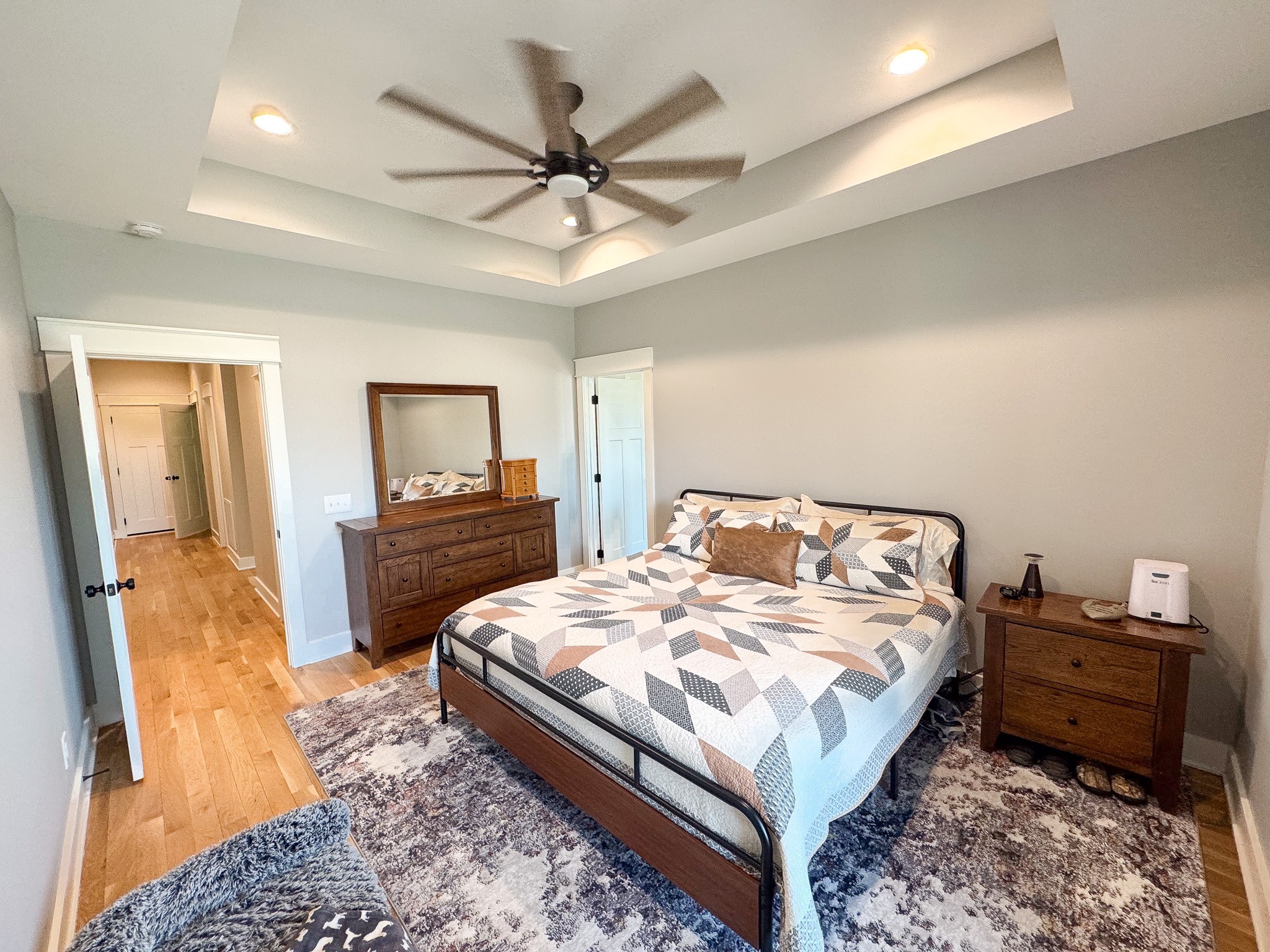 138 Belcher Hollow Road Cottontown, TN 37048 - Photo 46 of 60 a bedroom with a bed and a chandelier