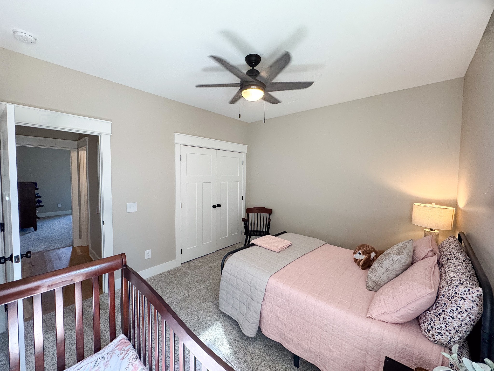 138 Belcher Hollow Road Cottontown, TN 37048 - Photo 55 of 60 a bedroom with a bed and a chandelier