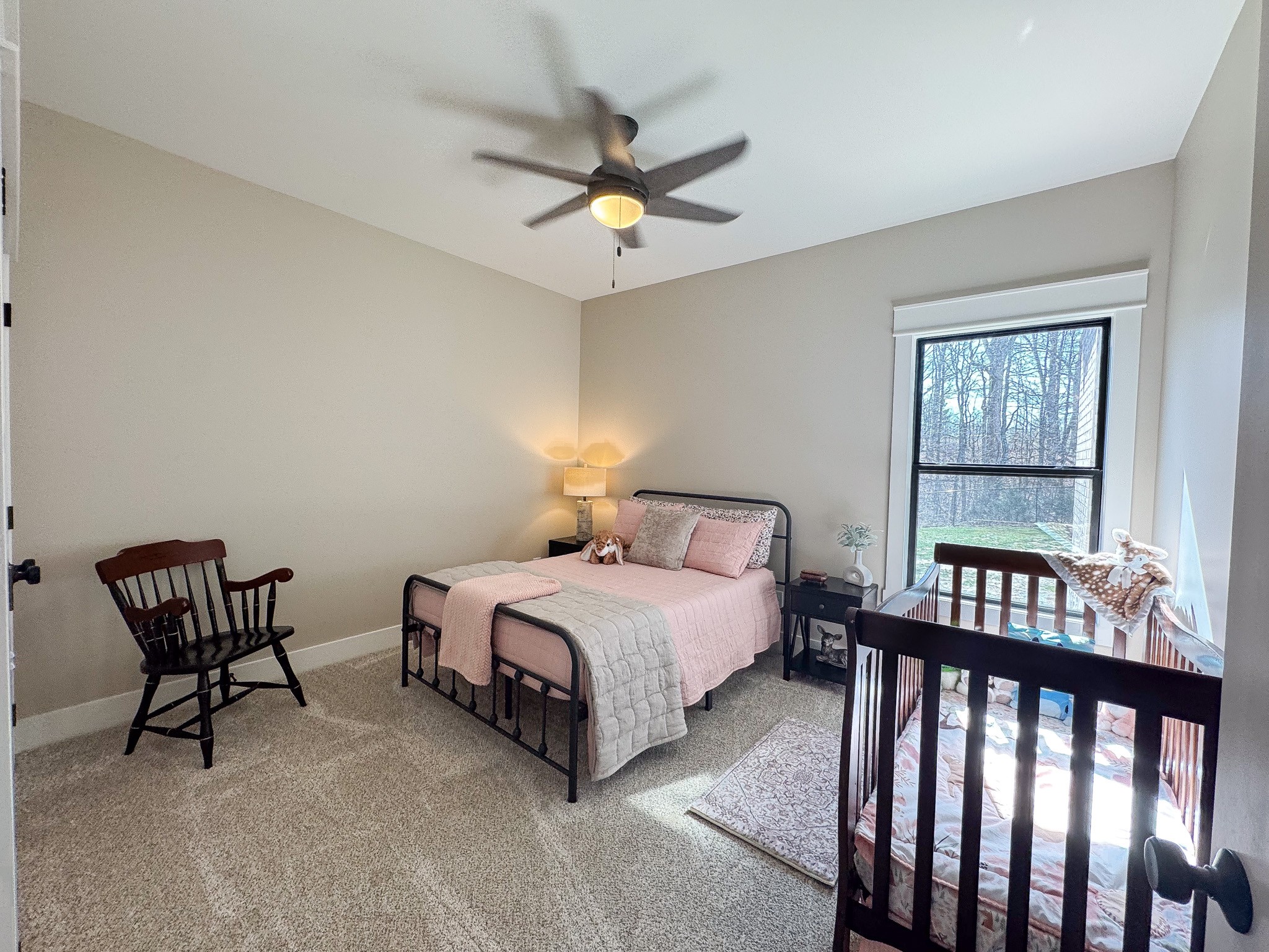 138 Belcher Hollow Road Cottontown, TN 37048 - Photo 56 of 60 a bedroom with a bed a window and chairs
