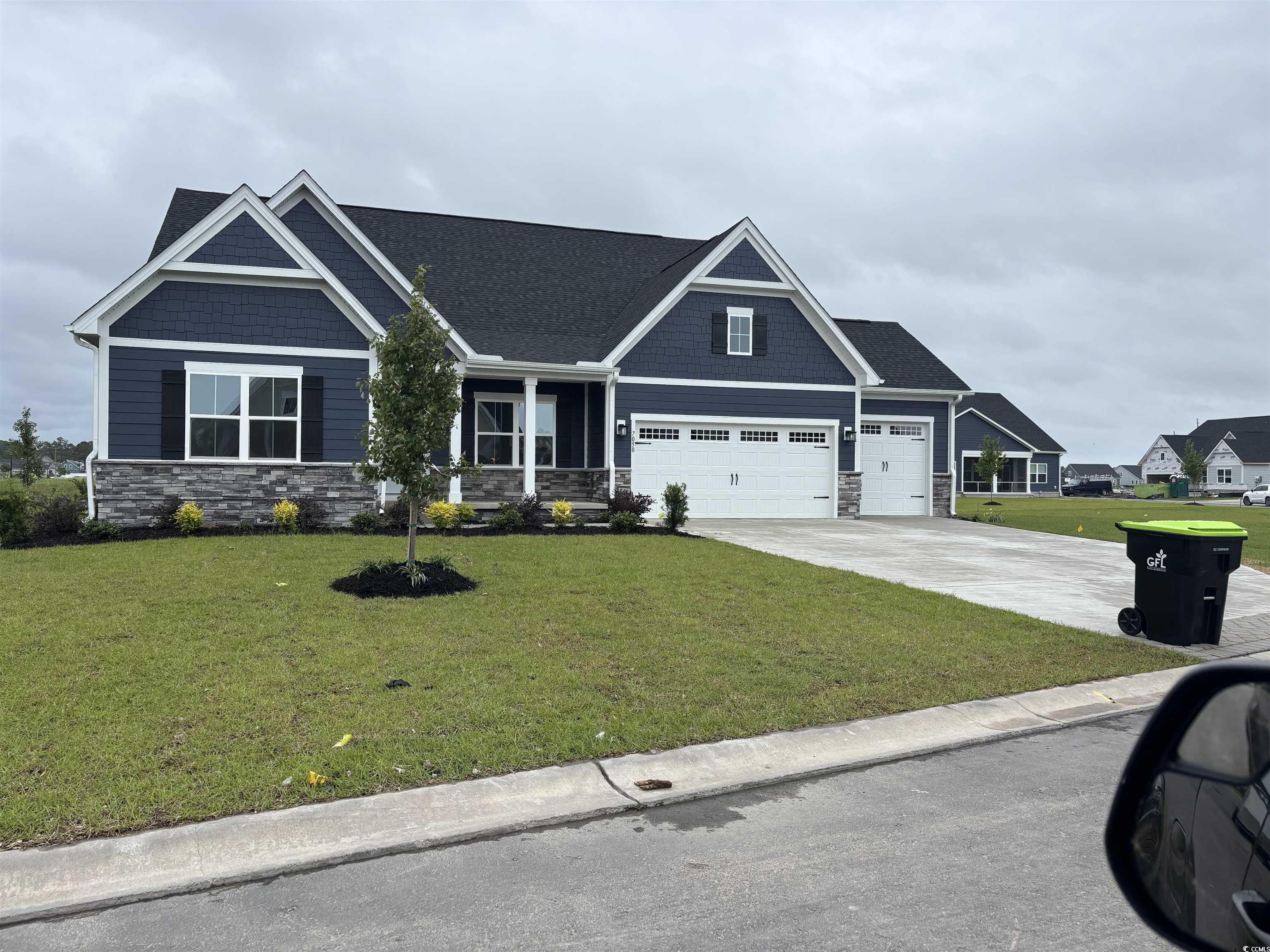 7050 Denim Loop Myrtle Beach, SC 29579 - Photo 1 of 1 Craftsman-style house with stone siding, an attach