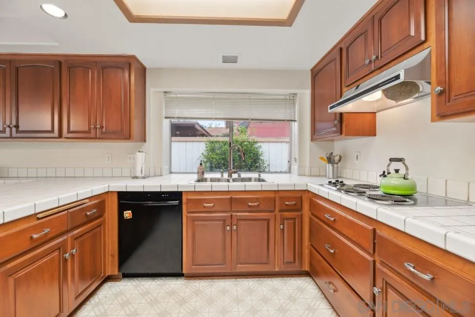13873 Carriage Road Poway, CA 92064 - Photo 12 of 32 a kitchen with a sink and cabinets
