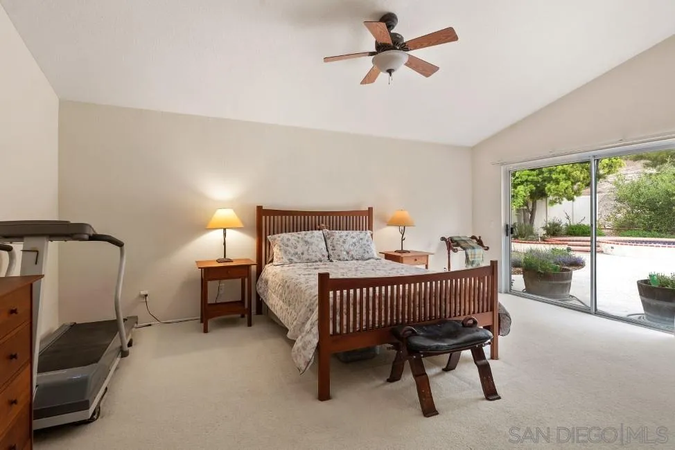 13873 Carriage Road Poway, CA 92064 - Photo 16 of 32 a bedroom with a bed a lamp and a bathtub