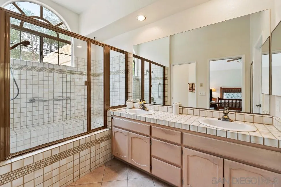 13873 Carriage Road Poway, CA 92064 - Photo 18 of 32 a bathroom with a granite countertop sink mirror and double