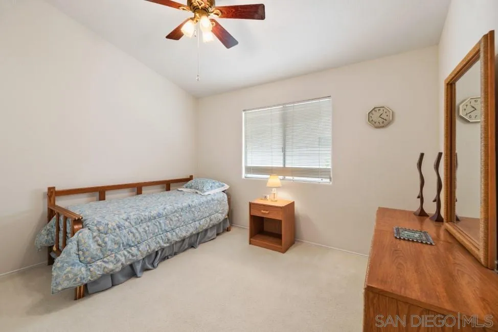 13873 Carriage Road Poway, CA 92064 - Photo 21 of 32 a bedroom with bed and window