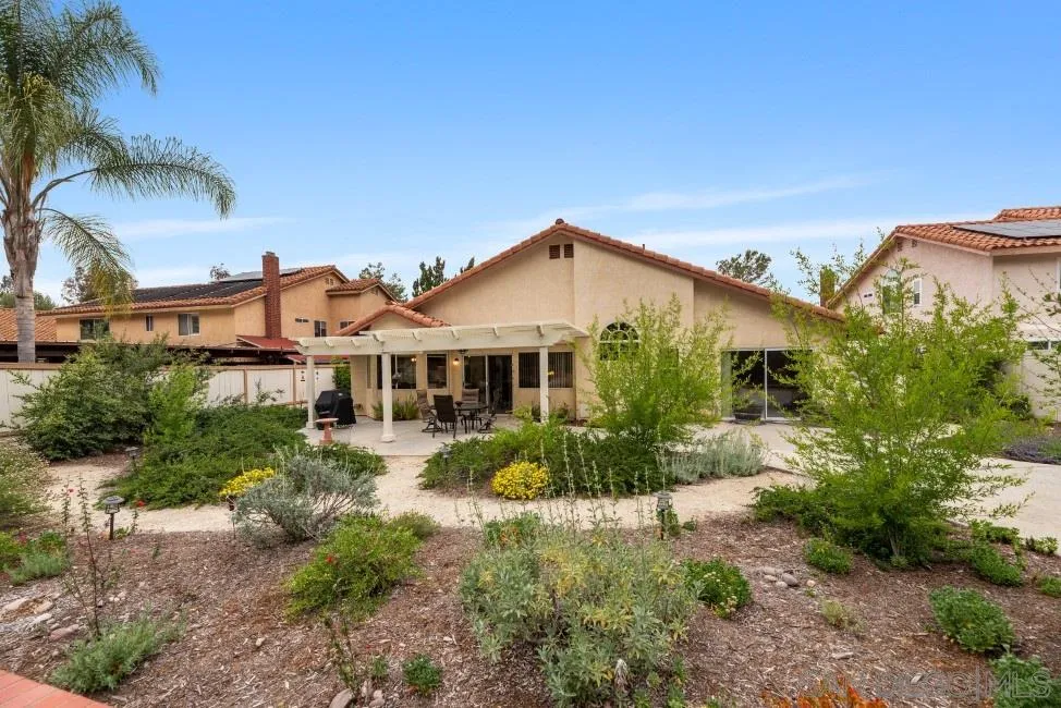 13873 Carriage Road Poway, CA 92064 - Photo 23 of 32 a view of a house with a big yard and potted plants