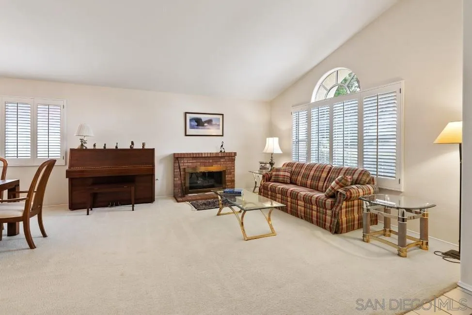 13873 Carriage Road Poway, CA 92064 - Photo 7 of 32 a living room with furniture a fireplace and a large window