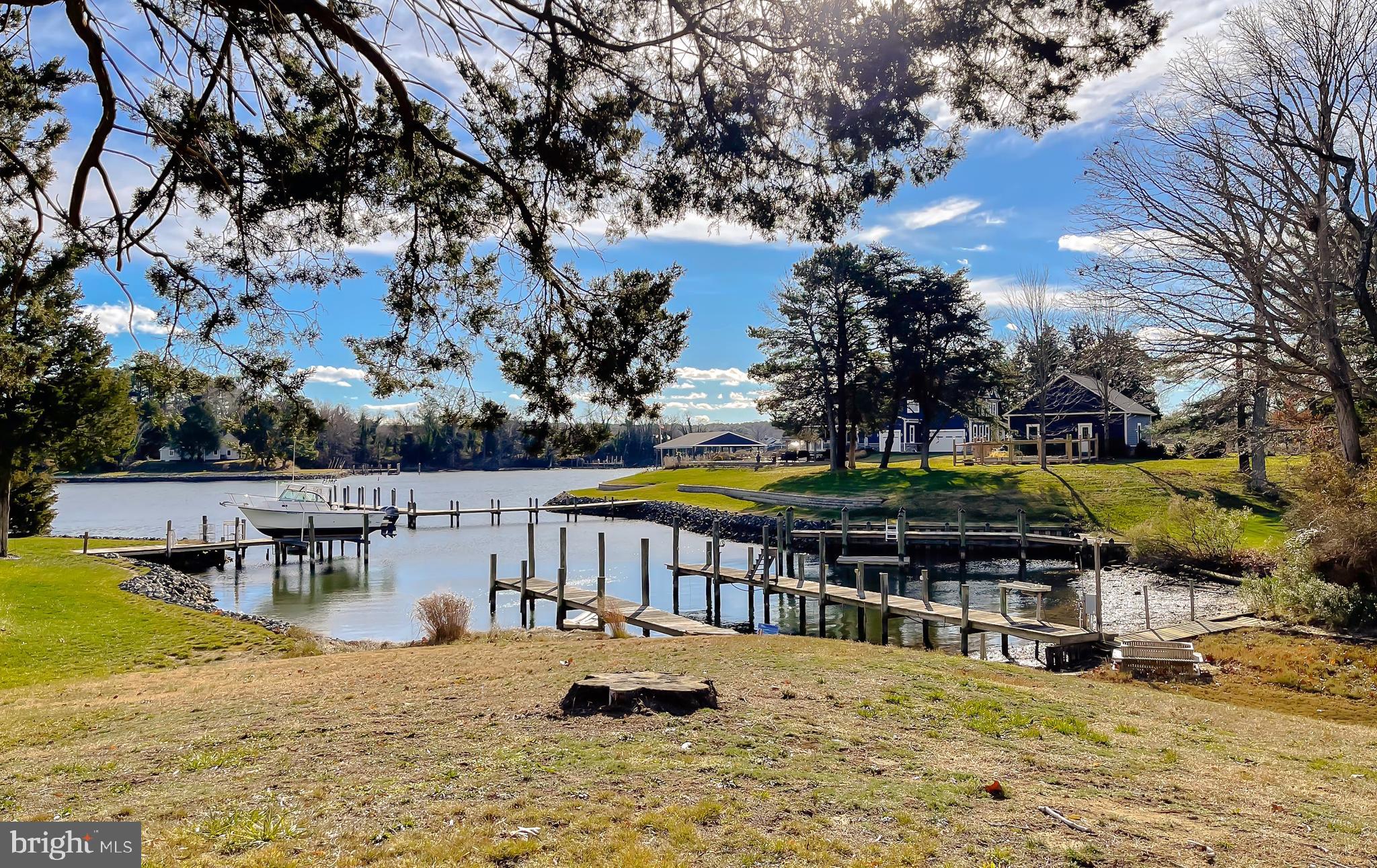 610 Rolling Hills Road Solomons, MD 20629 - Photo 3 of 33 a view of a swimming pool with an outdoor seating and a pathway