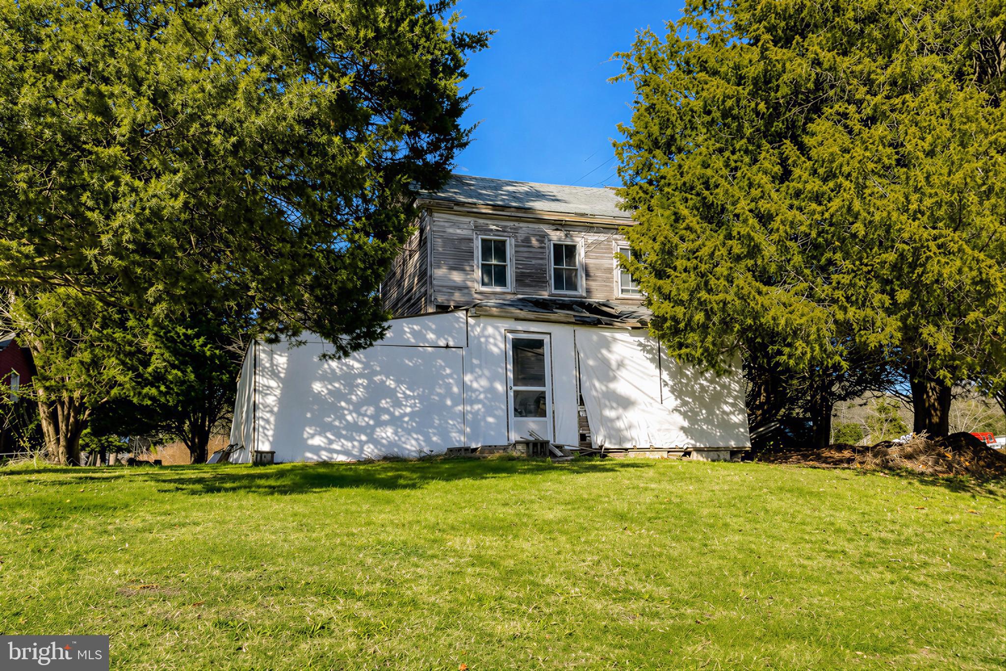 610 Rolling Hills Road Solomons, MD 20629 - Photo 36 of 43 a front view of house with yard and trees