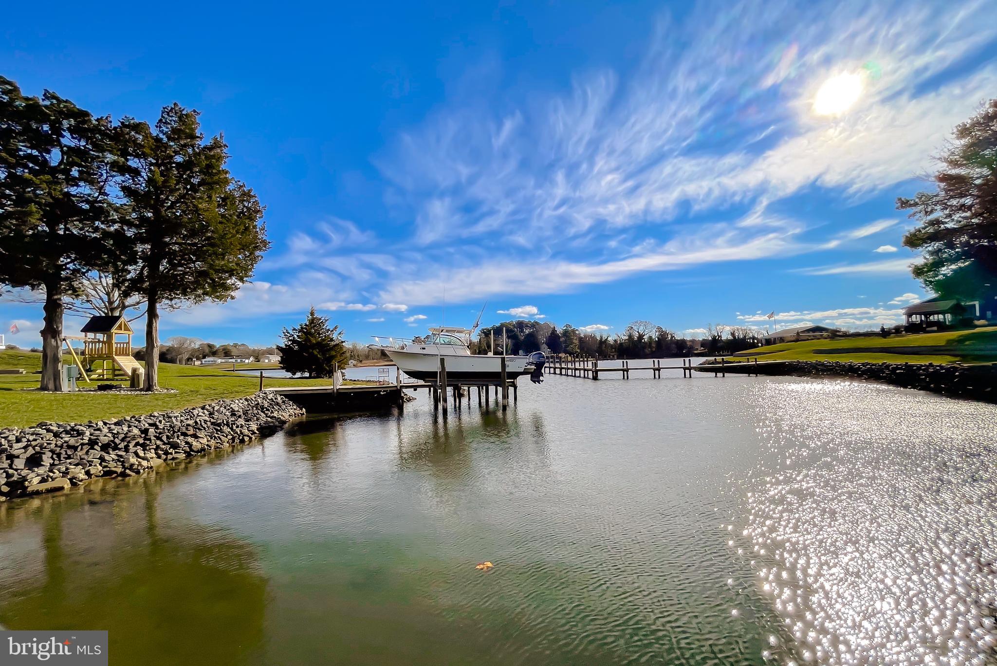 610 Rolling Hills Road Solomons, MD 20629 - Photo 8 of 33 a view of water with boats and trees in the background