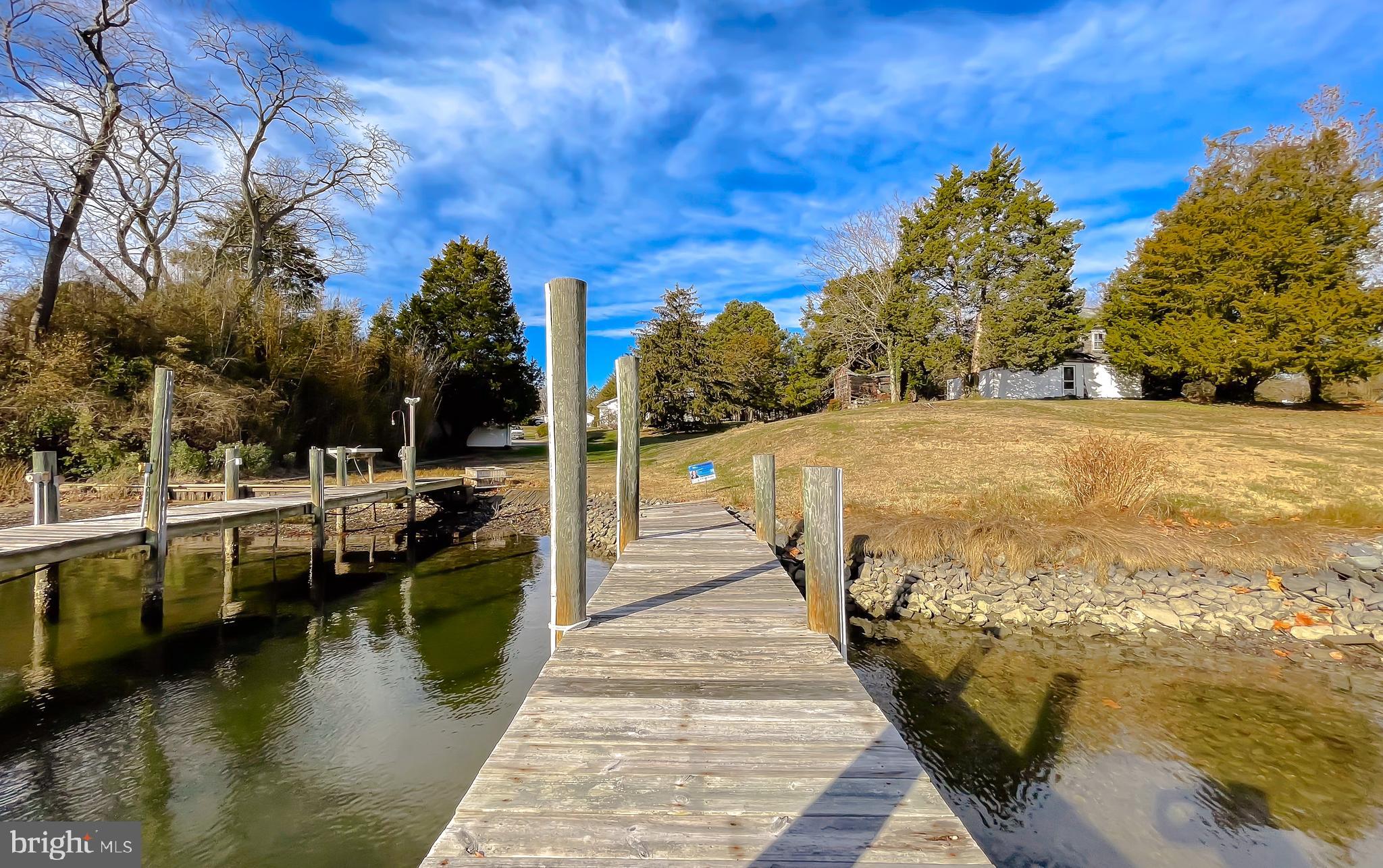 610 Rolling Hills Road Solomons, MD 20629 - Photo 9 of 43 a view of a lake with a large trees