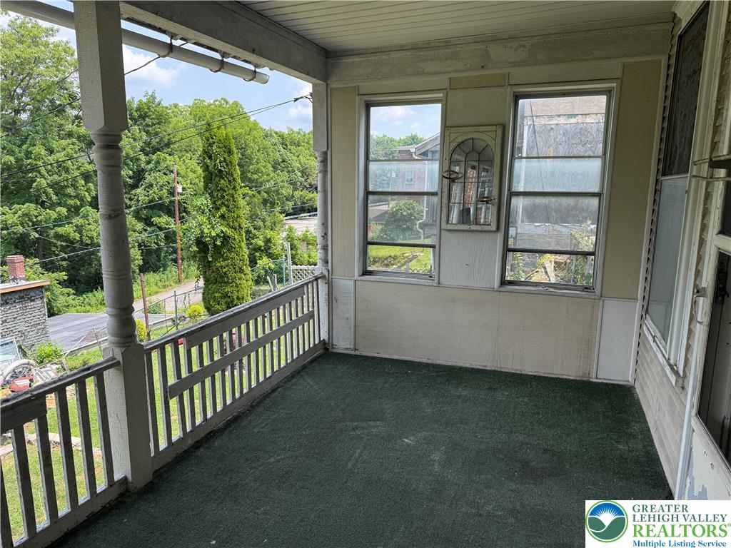 41 West Ridge Street Lansford, PA 18232 - Photo 13 of 40 An inviting porch provides elevated outdoor living with serene views of the surrounding natural landscape.