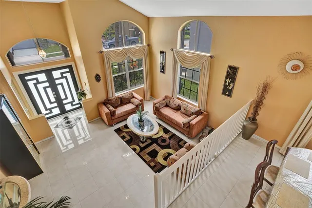a living room with furniture and a floor to ceiling window
