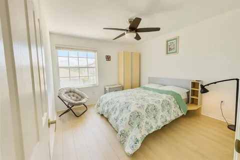 a bedroom with a bed and window