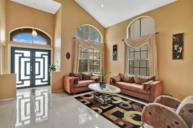 a living room with furniture and a large window