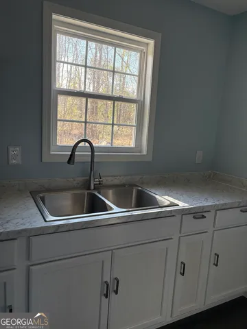a kitchen with a sink and cabinets