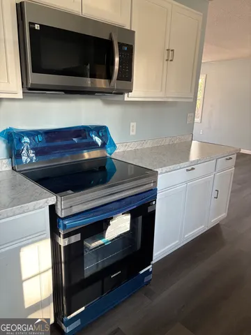 a kitchen with a stove and a microwave