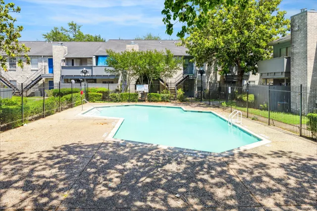 swimming pool with outdoor seating and yard