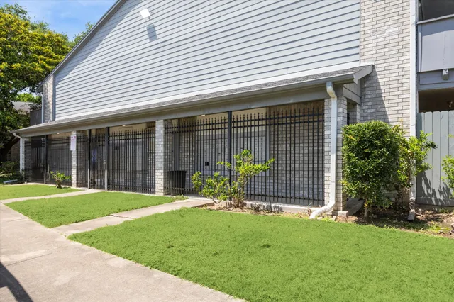 a front view of a house with a garden and yard
