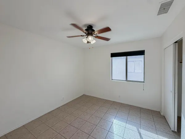 a view of a ceiling fan and hardwood floor