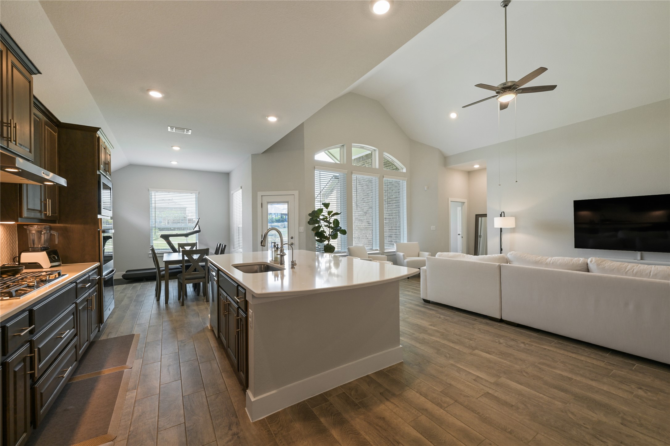 238 Wild Pecan Loop Buda, TX 78610 - Photo 10 of 31 Soaring vaulted ceilings and durable wood-look flooring anchor this airy, open-concept living pavilion.