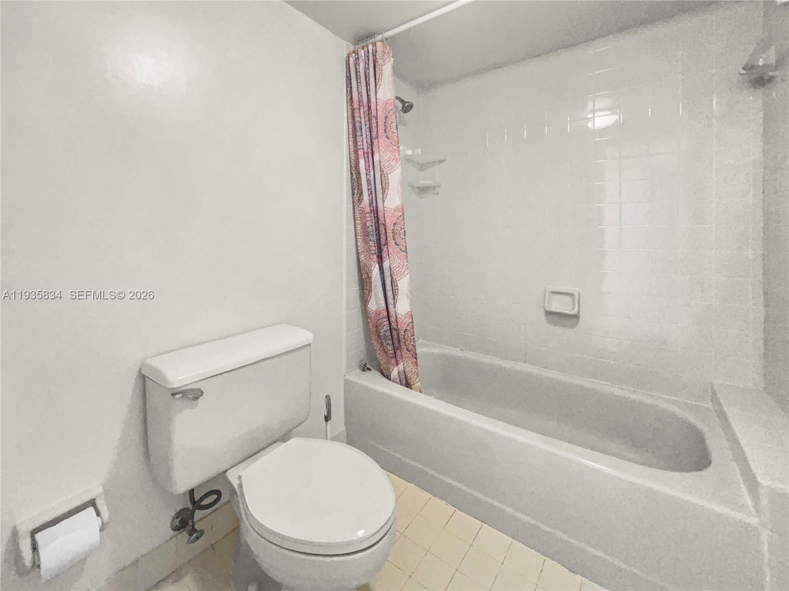 9255 Southwest 125th Avenue, Unit R308 Miami, FL 33186 - Photo 7 of 19 a white toilet sitting next to a bath tub