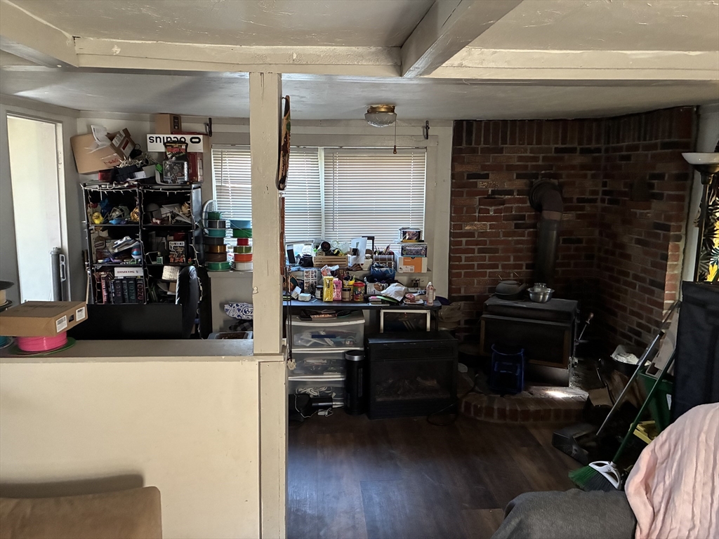 129 Commercial Street Whitman, MA 02382 - Photo 6 of 10 a living room with furniture a flat screen tv and a fireplace