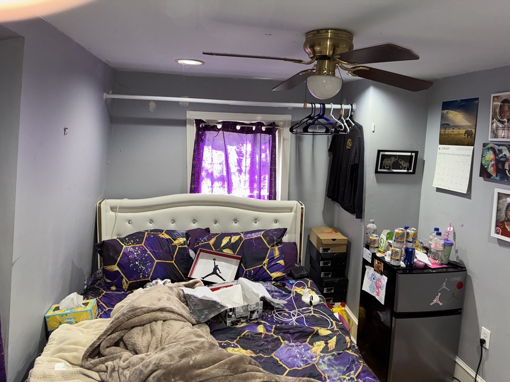 129 Commercial Street Whitman, MA 02382 - Photo 10 of 10 a bed room with a bed and a chandelier