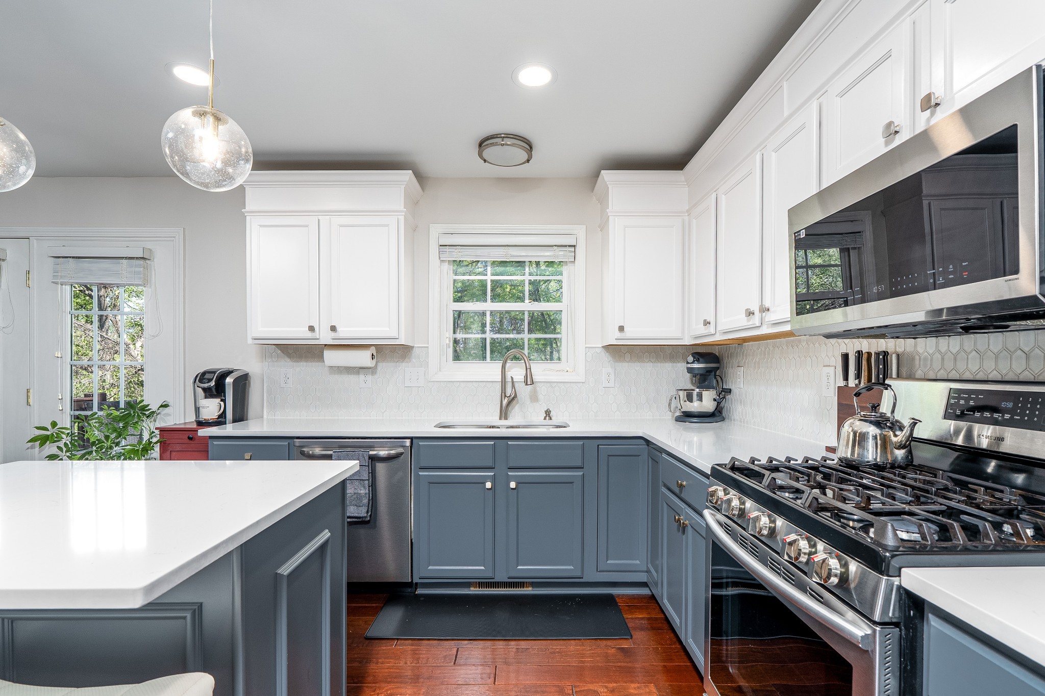 2102 Burgess Lane Spring Hill, TN 37174 - Photo 7 of 45 a kitchen with stainless steel appliances a sink a stove a microwave cabinets and a window