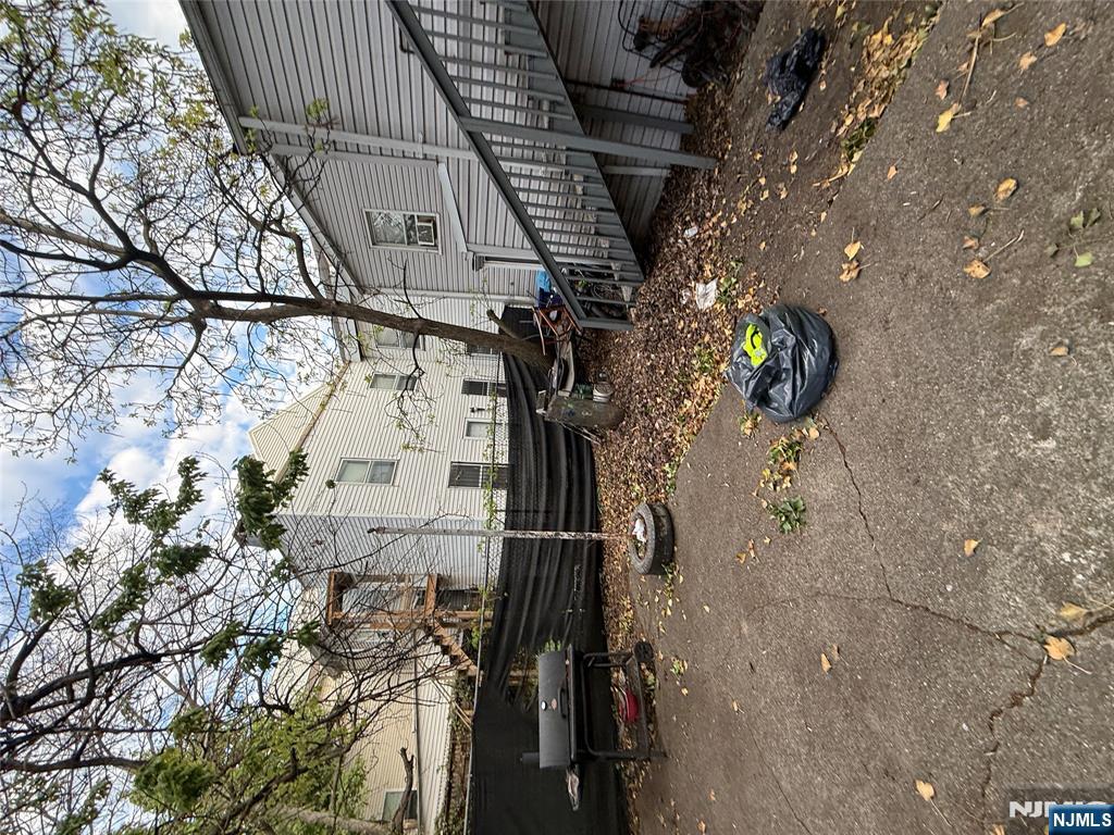 63 Pearl Street Paterson, NJ 07501 - Photo 15 of 16 a front view of a house with a garden