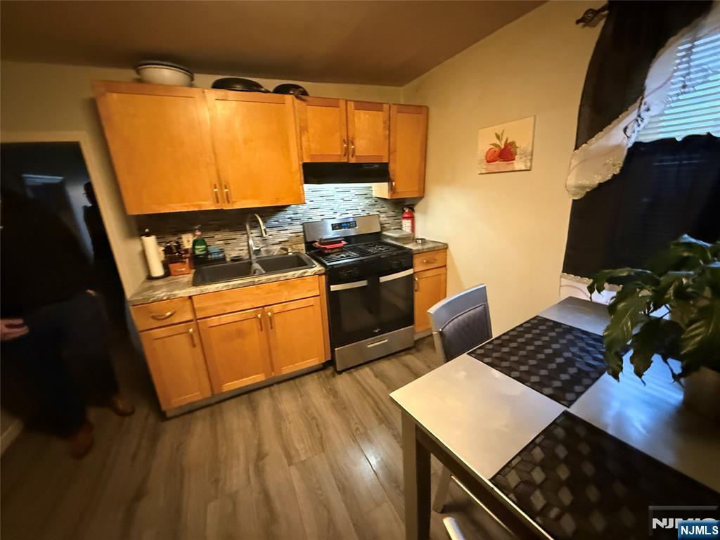 63 Pearl Street Paterson, NJ 07501 - Photo 5 of 16 a kitchen with a stove and a refrigerator