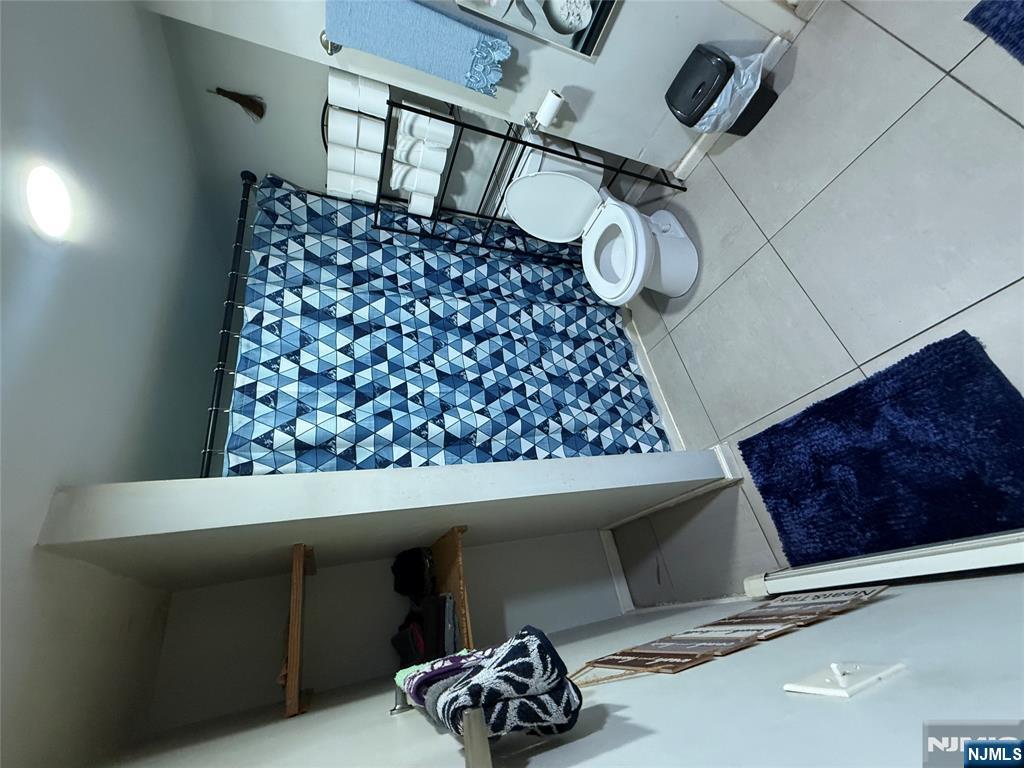 63 Pearl Street Paterson, NJ 07501 - Photo 7 of 16 a bathroom with a toilet and a shower
