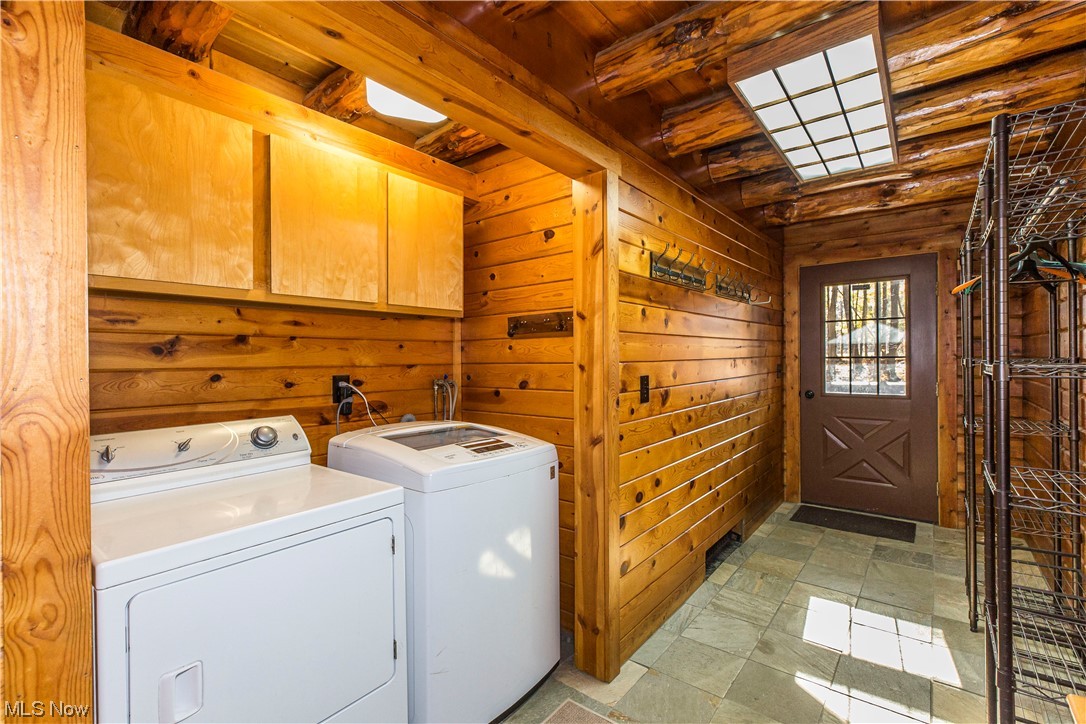 4069 Erhart Road Medina, OH 44256 - Photo 15 of 30 Washroom featuring washer and dryer, wooden walls, light tile floors, cabinets, and wooden ceiling