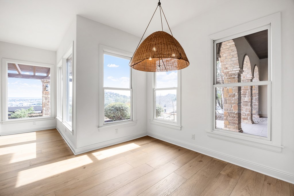 3613 Ranch View Court Kerrville, TX 78028 - Photo 13 of 41 a view of an empty room with a window and wooden floor