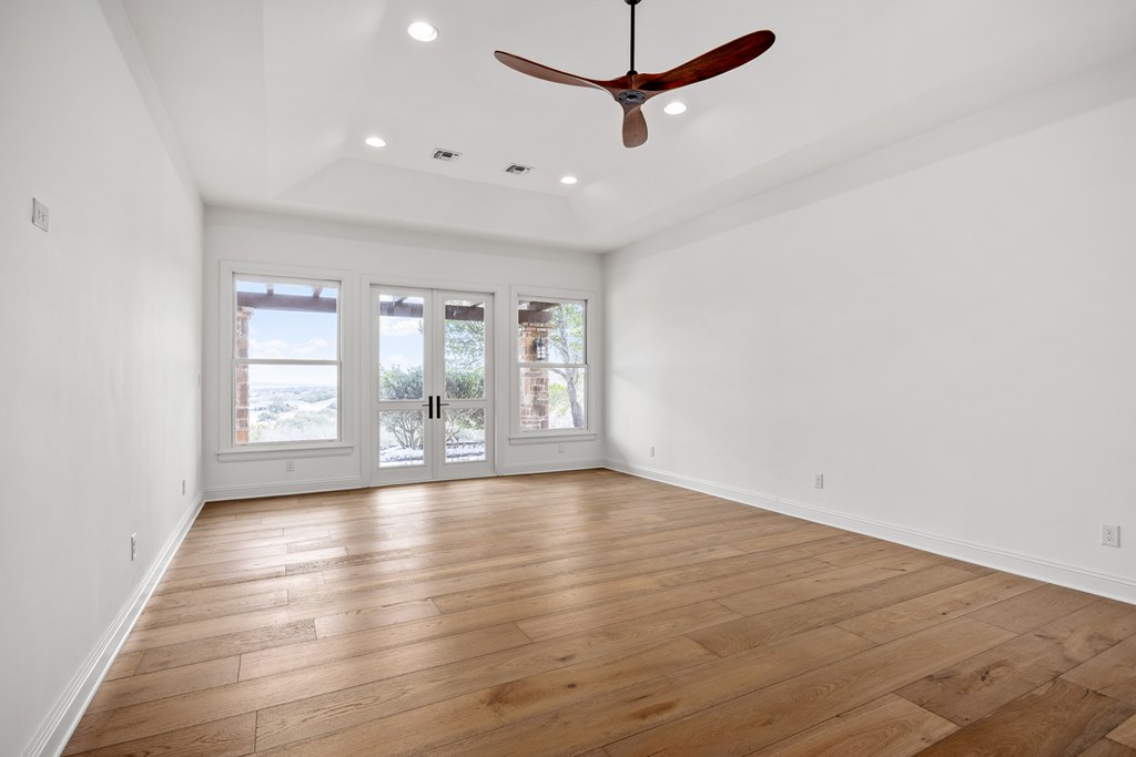 3613 Ranch View Court Kerrville, TX 78028 - Photo 16 of 41 an empty room with wooden floor and windows
