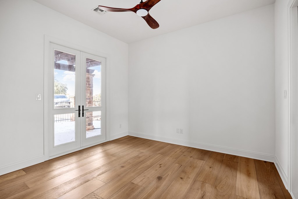 3613 Ranch View Court Kerrville, TX 78028 - Photo 23 of 41 an empty room with wooden floor and windows