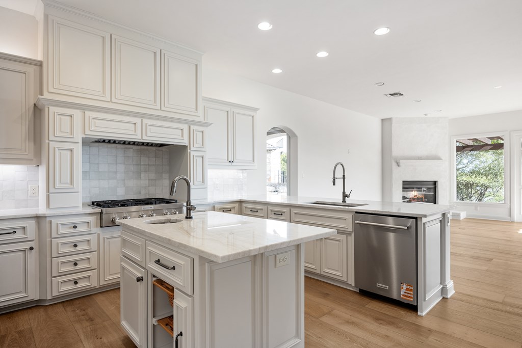 3613 Ranch View Court Kerrville, TX 78028 - Photo 10 of 41 a kitchen with granite countertop a sink stove and cabinets